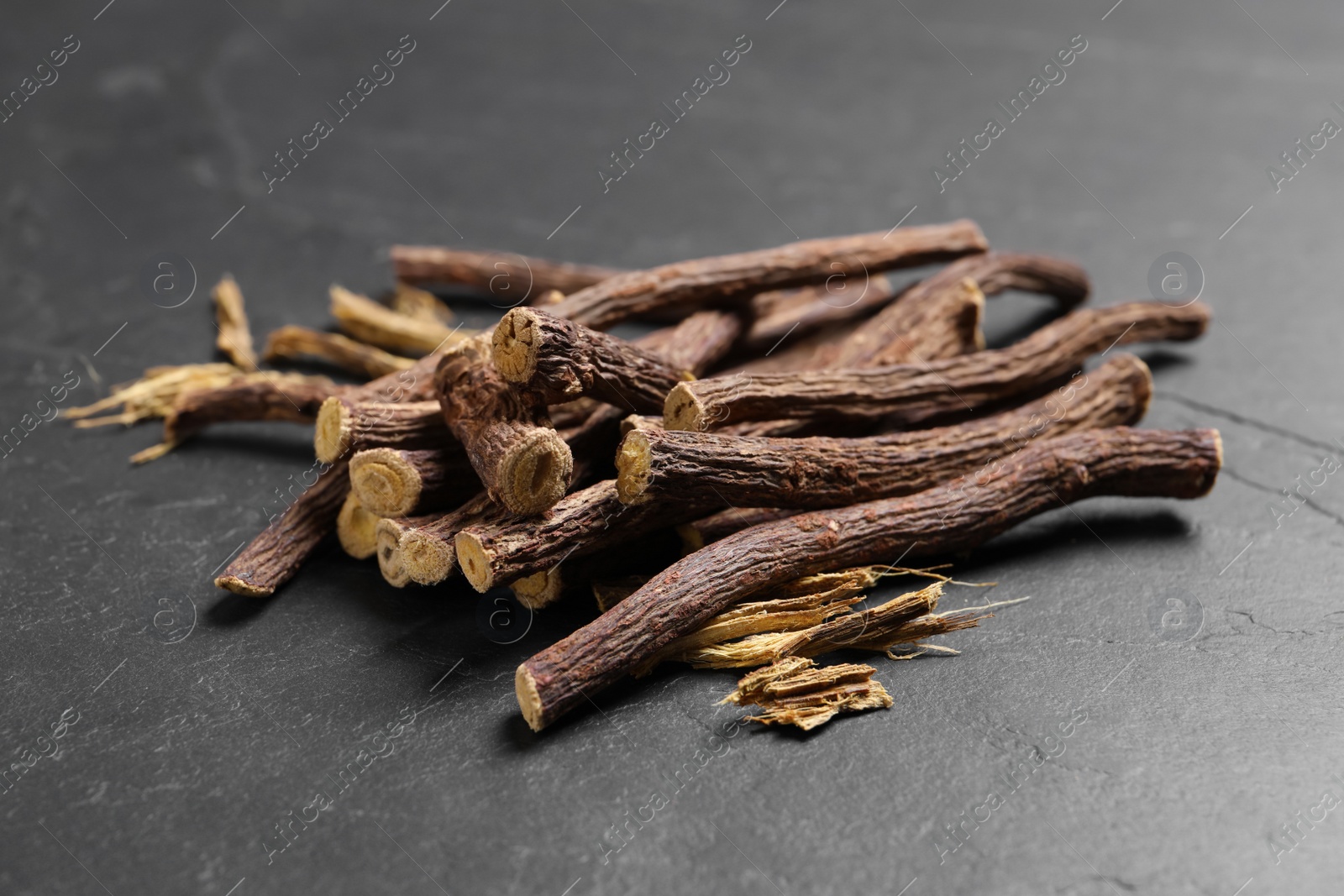 Photo of Dried sticks of liquorice root on black table