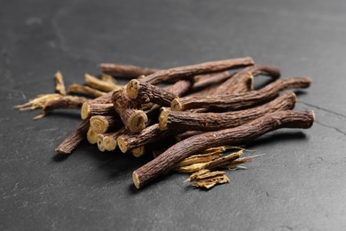 Photo of Dried sticks of liquorice root on black table