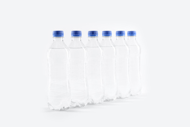 Plastic bottles with pure water on white background