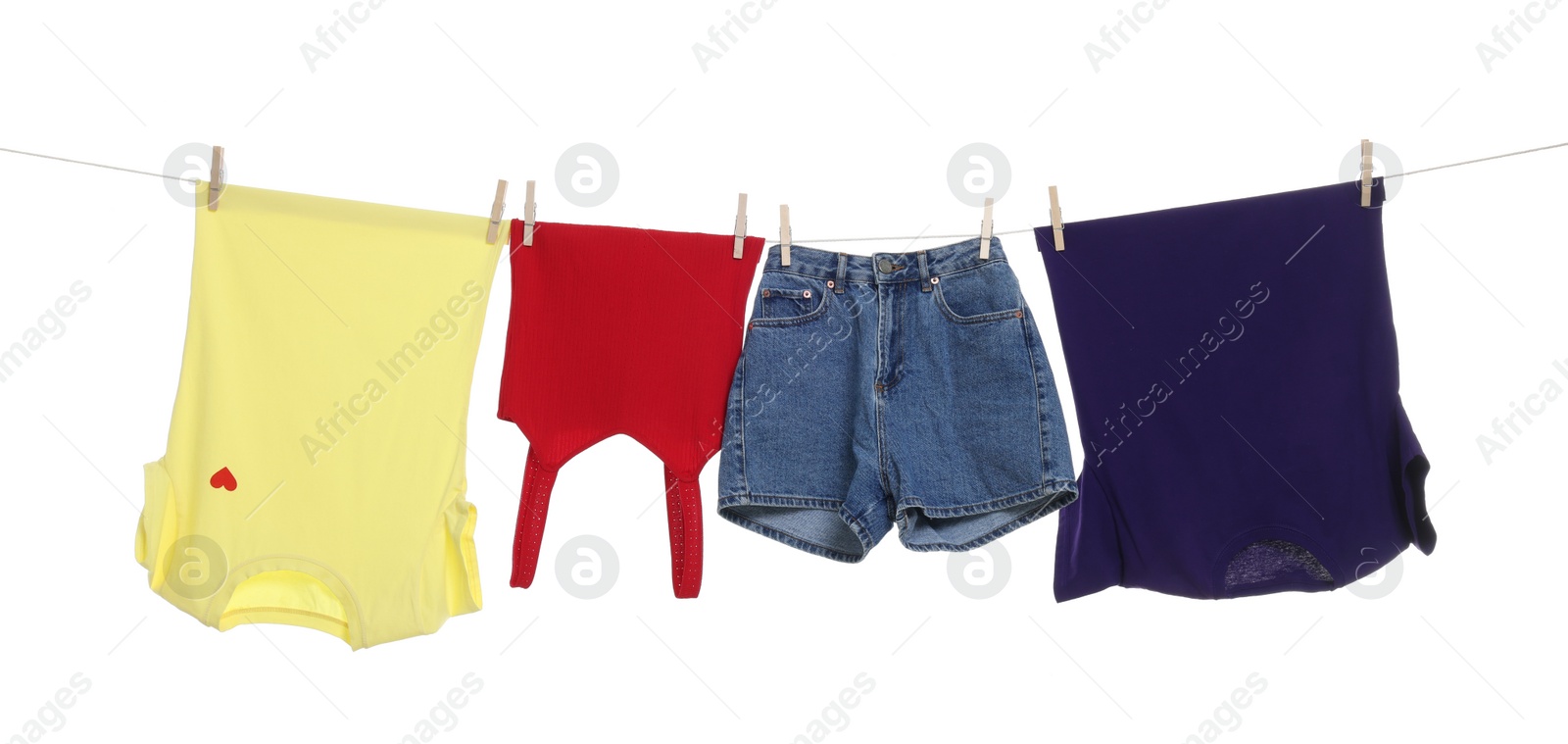 Photo of Different clothes drying on laundry line against white background