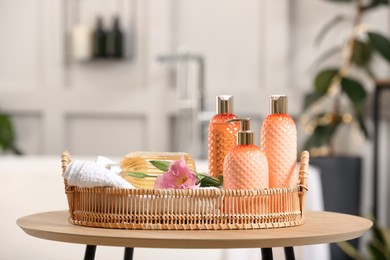 Photo of Liquid soap and other toiletries on wooden table indoors