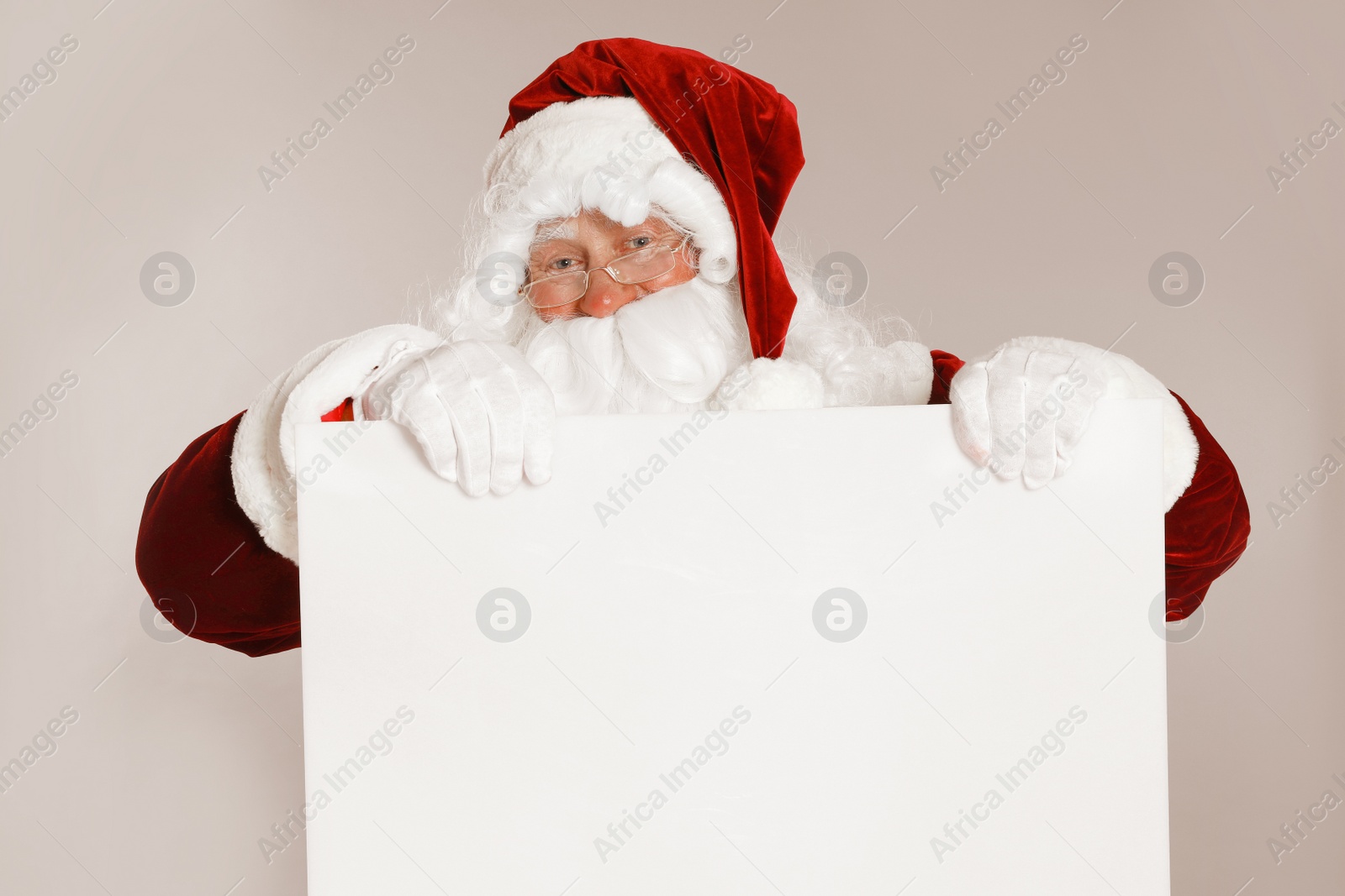 Photo of Authentic Santa Claus with blank banner on grey background. Space for design