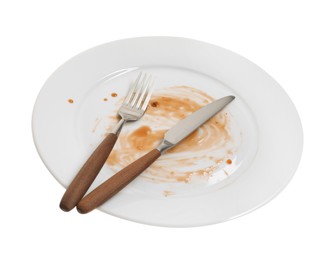 Dirty plate and cutlery on white background