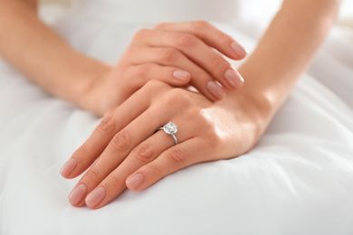 Young bride wearing beautiful engagement ring, closeup