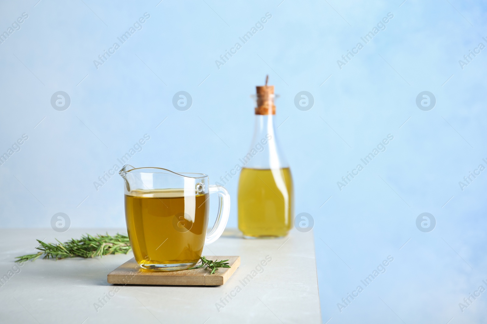 Photo of Composition with fresh rosemary oil on table