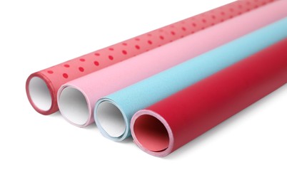 Photo of Rolls of colorful wrapping papers on white background
