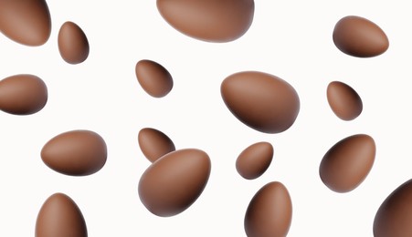 Image of Many chocolate eggs falling on white background