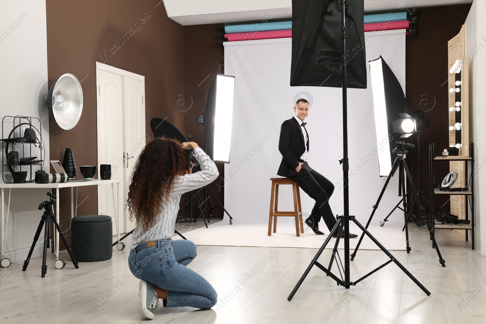 Photo of Handsome model posing for professional photographer in studio