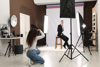 Handsome model posing for professional photographer in studio