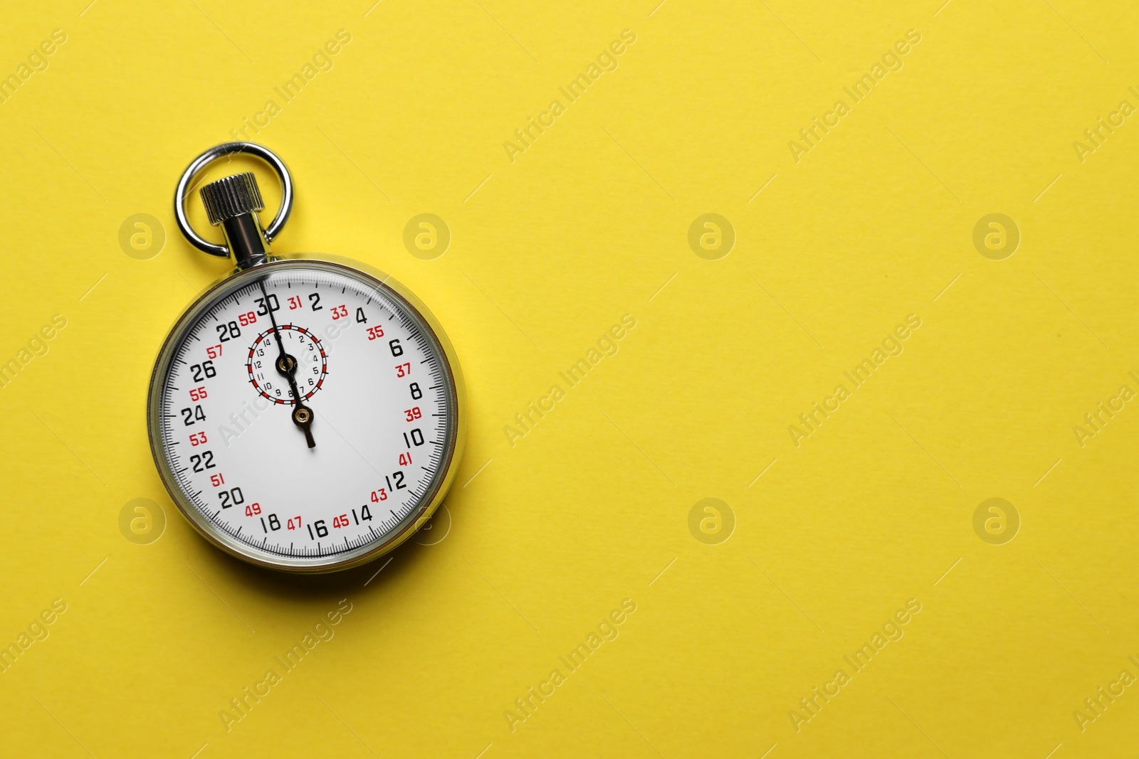 Photo of Vintage timer on yellow background, top view. Space for text