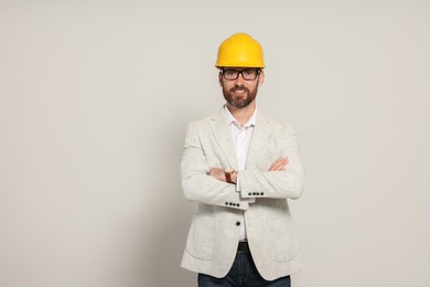 Photo of Professional engineer in hard hat on white background