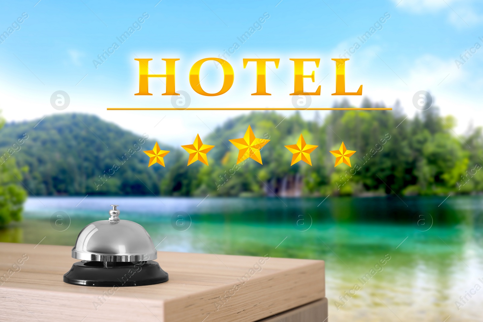 Image of 5 Star hotel. Reception desk with service bell and picturesque landscape on background