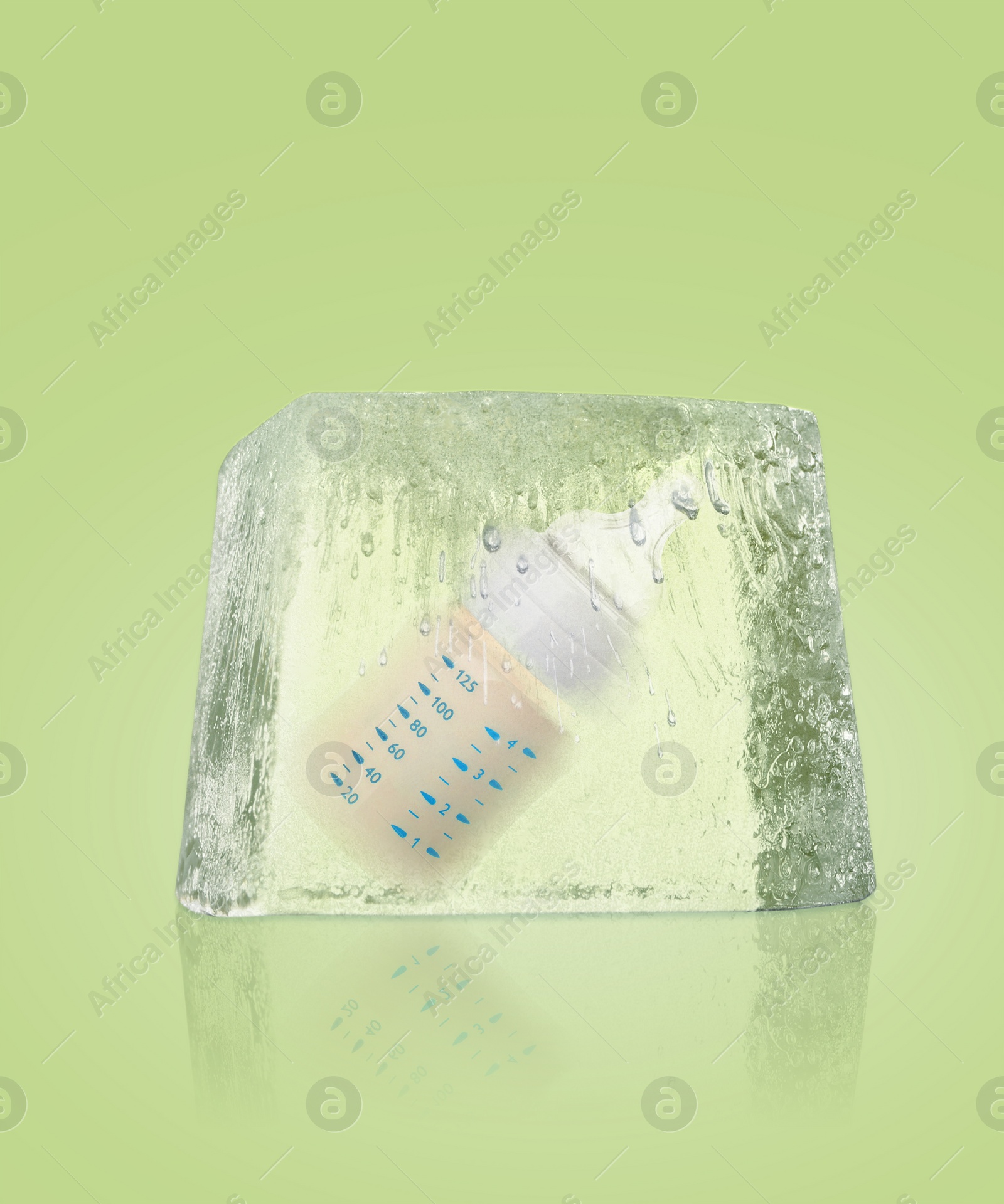 Image of Conservation of genetic material. Baby feeding bottle in ice cube as cryopreservation on light green background