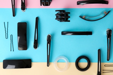 Photo of Flat lay composition with professional hairdresser tools on color background