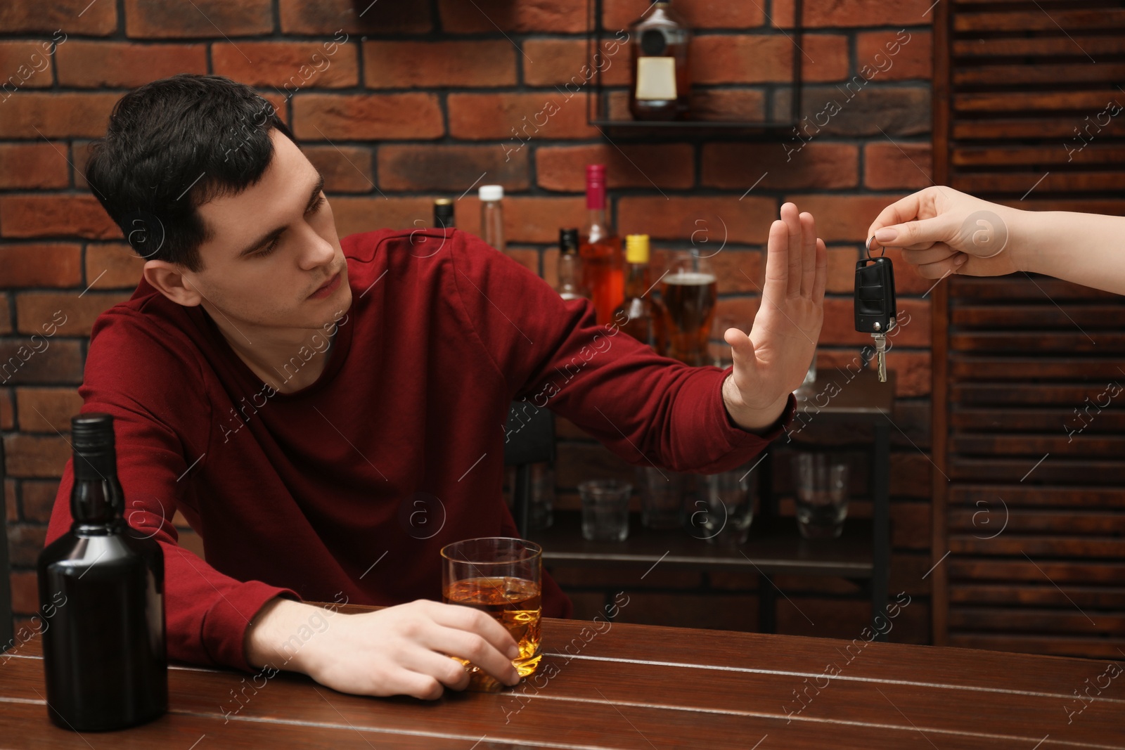 Photo of Drunk man refusing drive car while woman suggesting him keys, closeup. Don't drink and drive concept