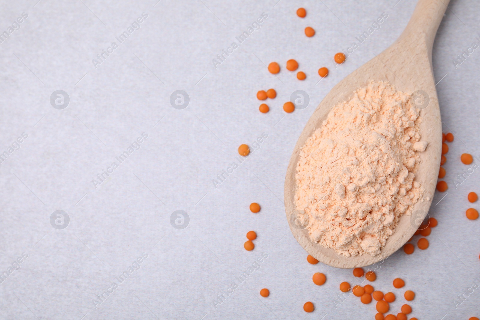 Photo of Spoon of lentil flour and seeds on white table, flat lay. Space for text