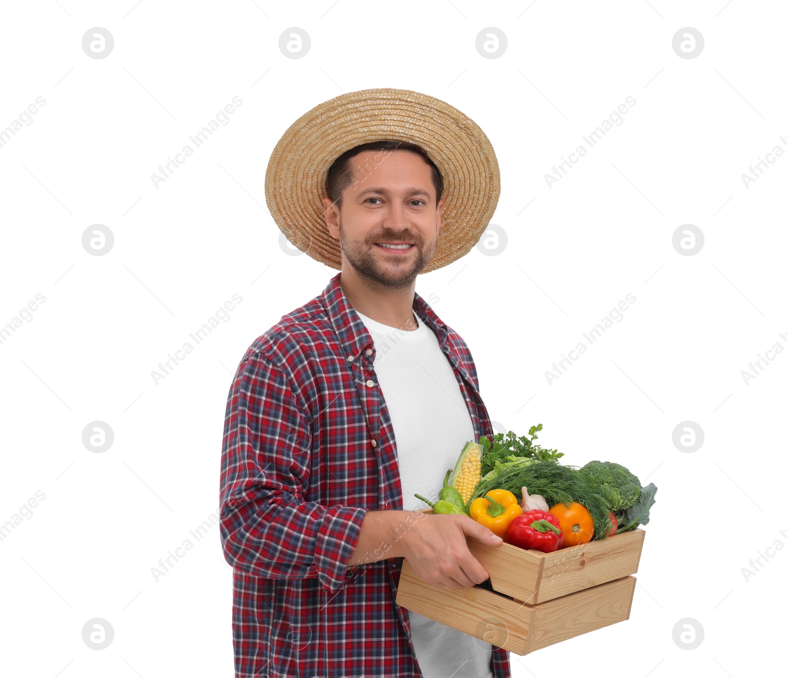 Photo of Harvesting season. Happy farmer holding wooden crate with vegetables on white background