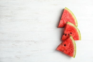 Flat lay composition with watermelon slices on white wooden background