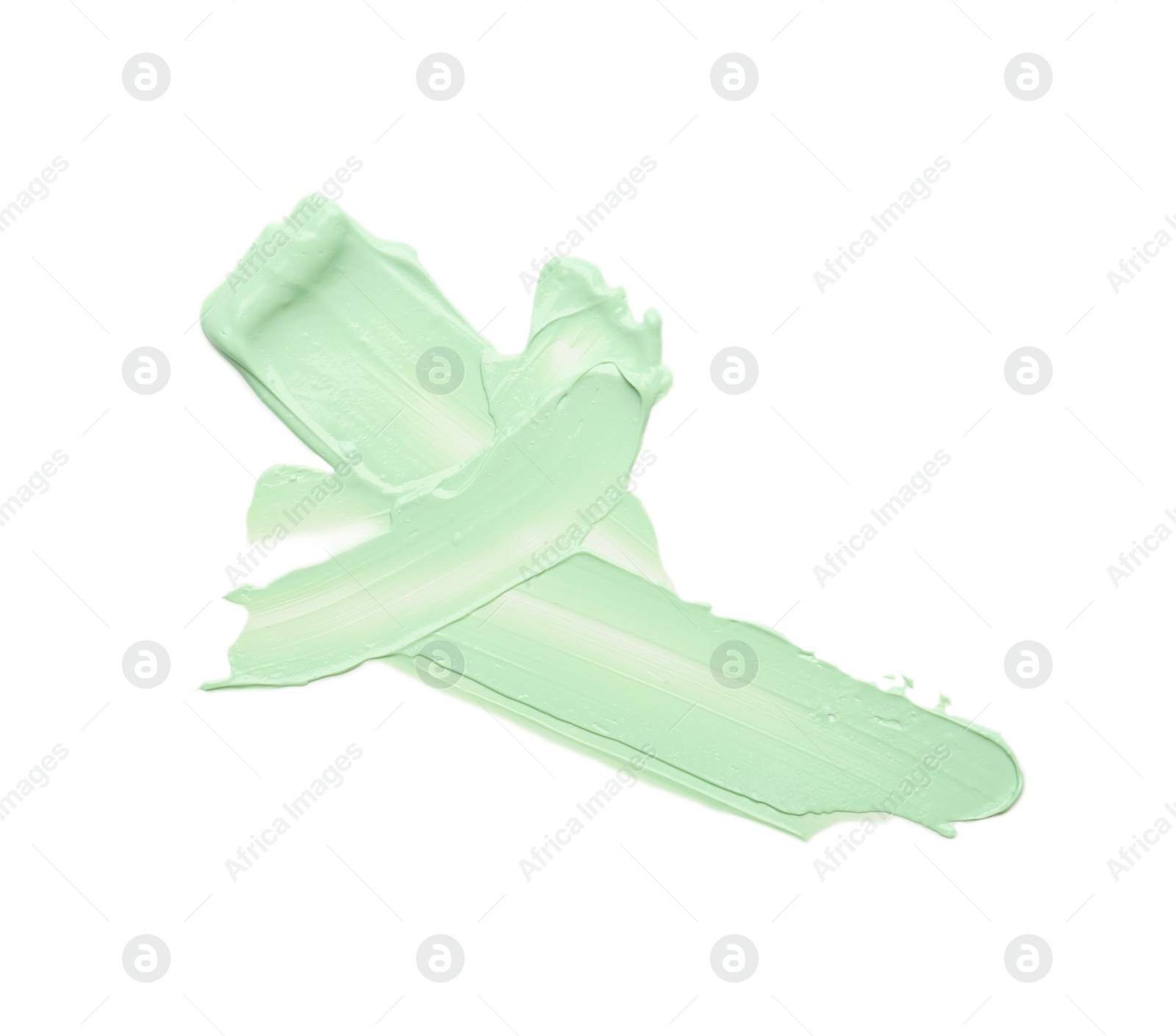 Photo of Strokes of green color correcting concealer isolated on white, top view