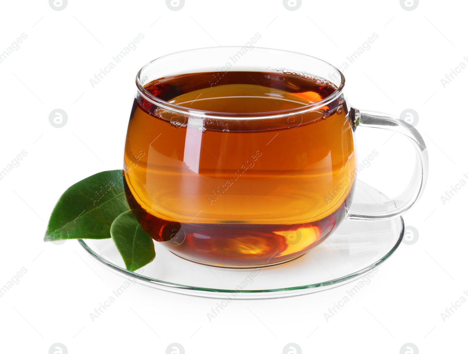 Photo of Aromatic tea in glass cup and green leaves isolated on white