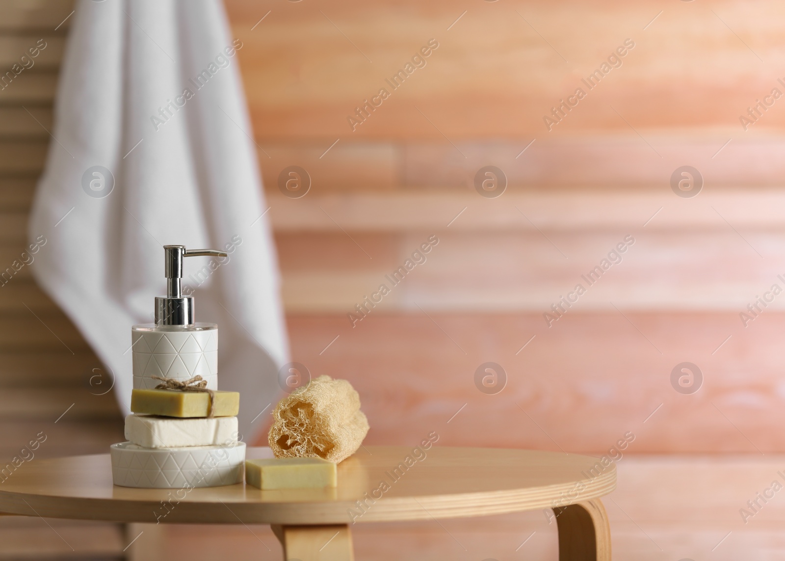 Photo of Composition with soap and toiletries on table against blurred background. Space for text