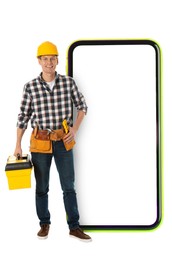 Repair service - just call. Happy professional repairman holding toolbox and smartphone with blank screen on white background, space for design