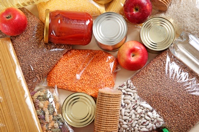 Photo of Many different products on table, top view. Food donation