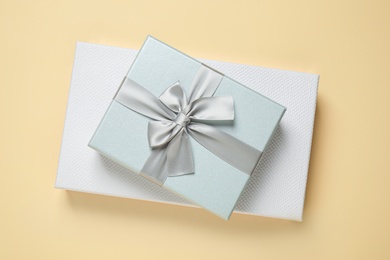 Photo of Beautiful gift boxes on beige background, top view