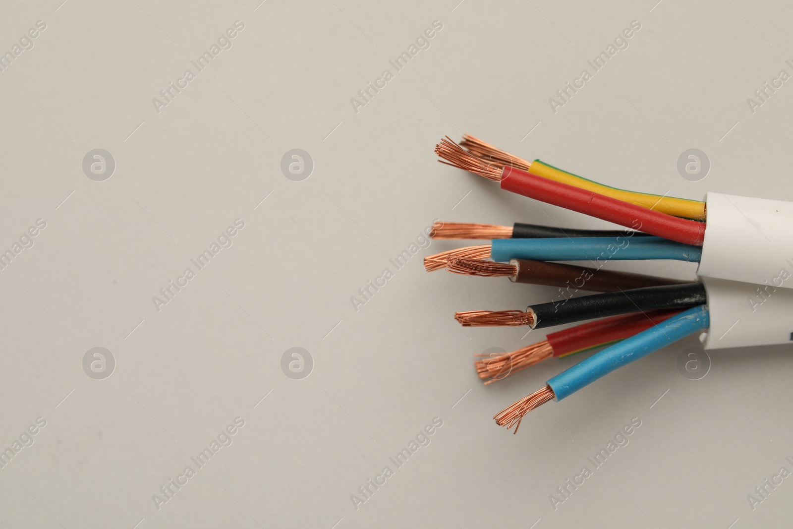 Photo of Electrical wires on light background, top view. Space for text