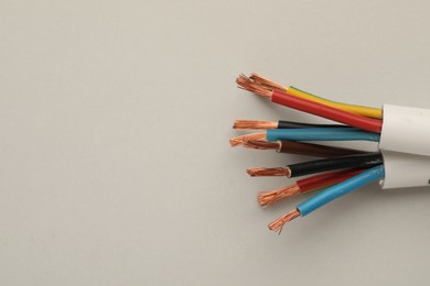 Photo of Electrical wires on light background, top view. Space for text