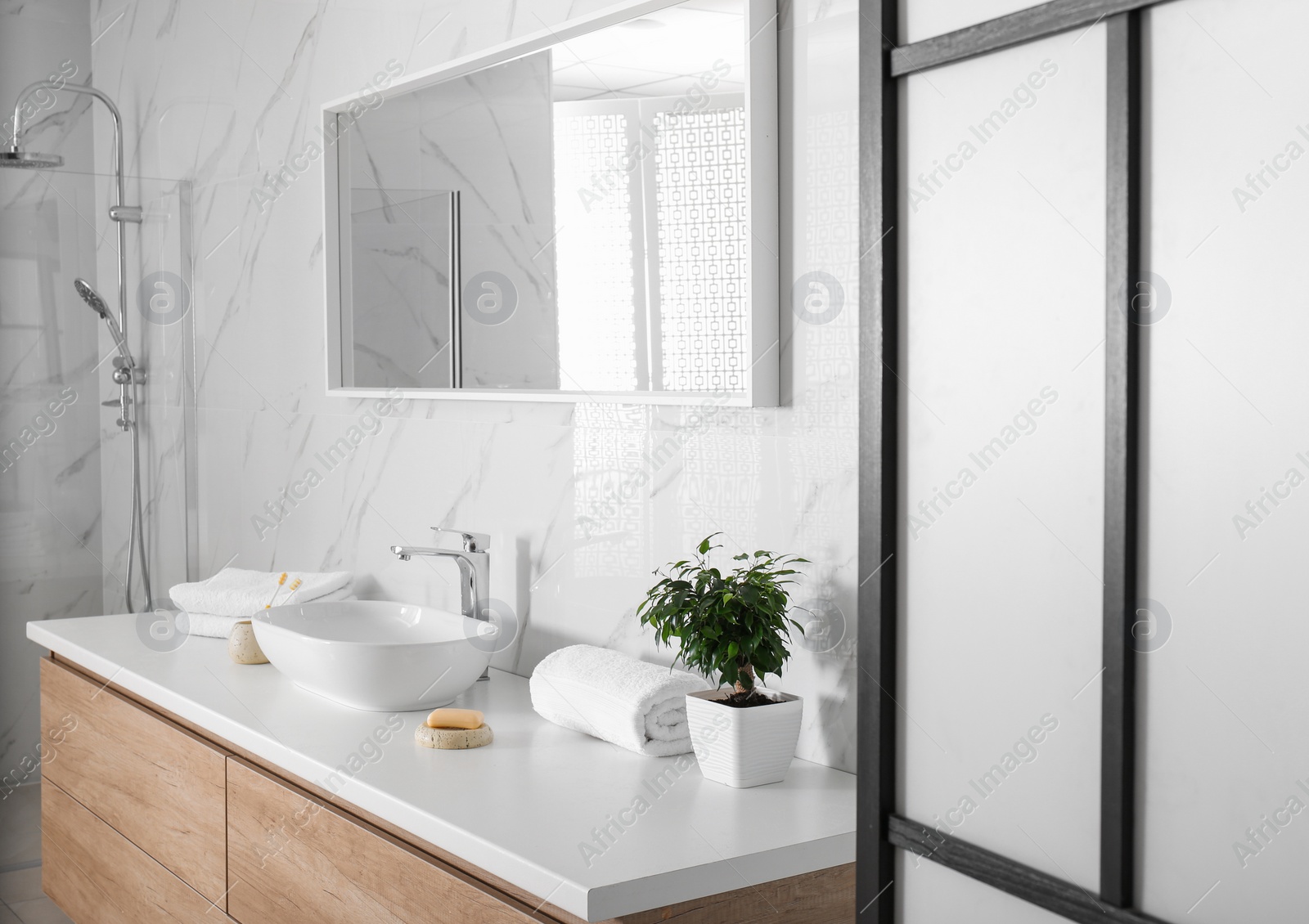 Photo of Modern mirror and vessel sink in stylish bathroom