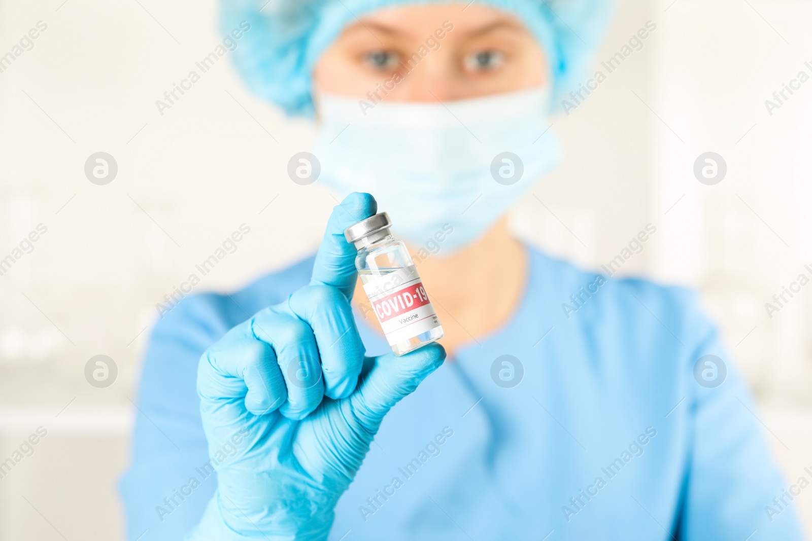 Photo of Doctor with coronavirus vaccine in laboratory, focus on hand