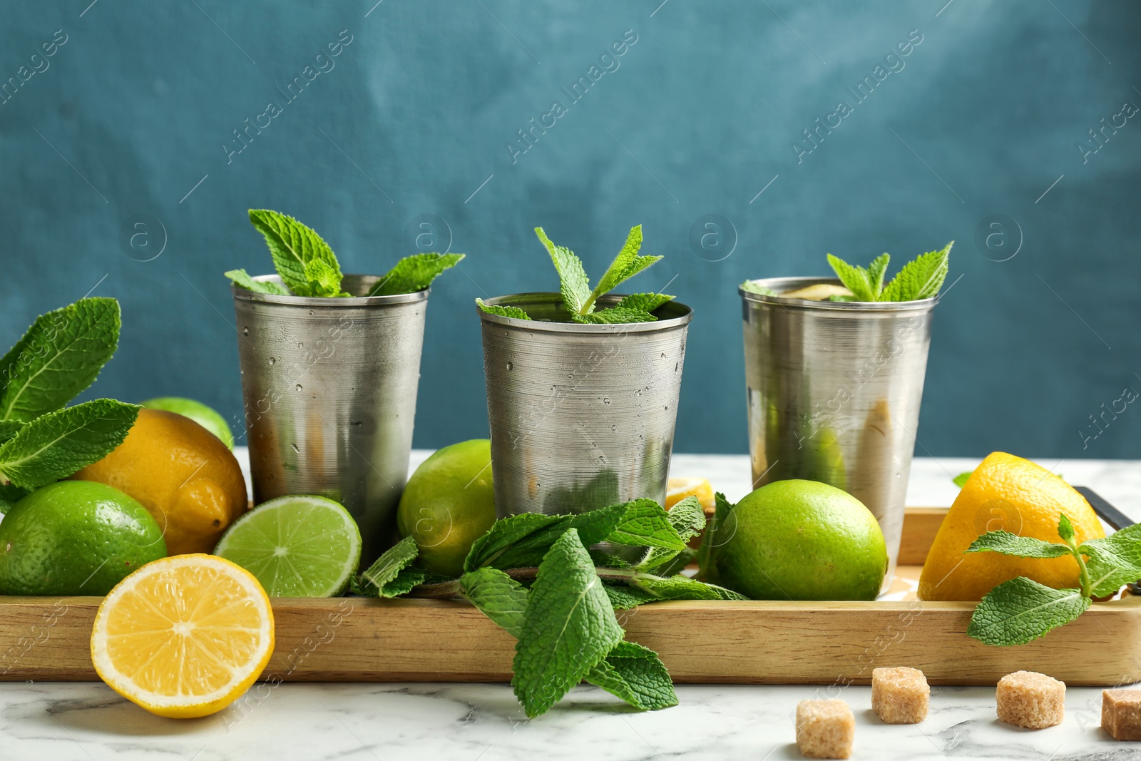 Photo of Composition with delicious mint julep cocktail on table