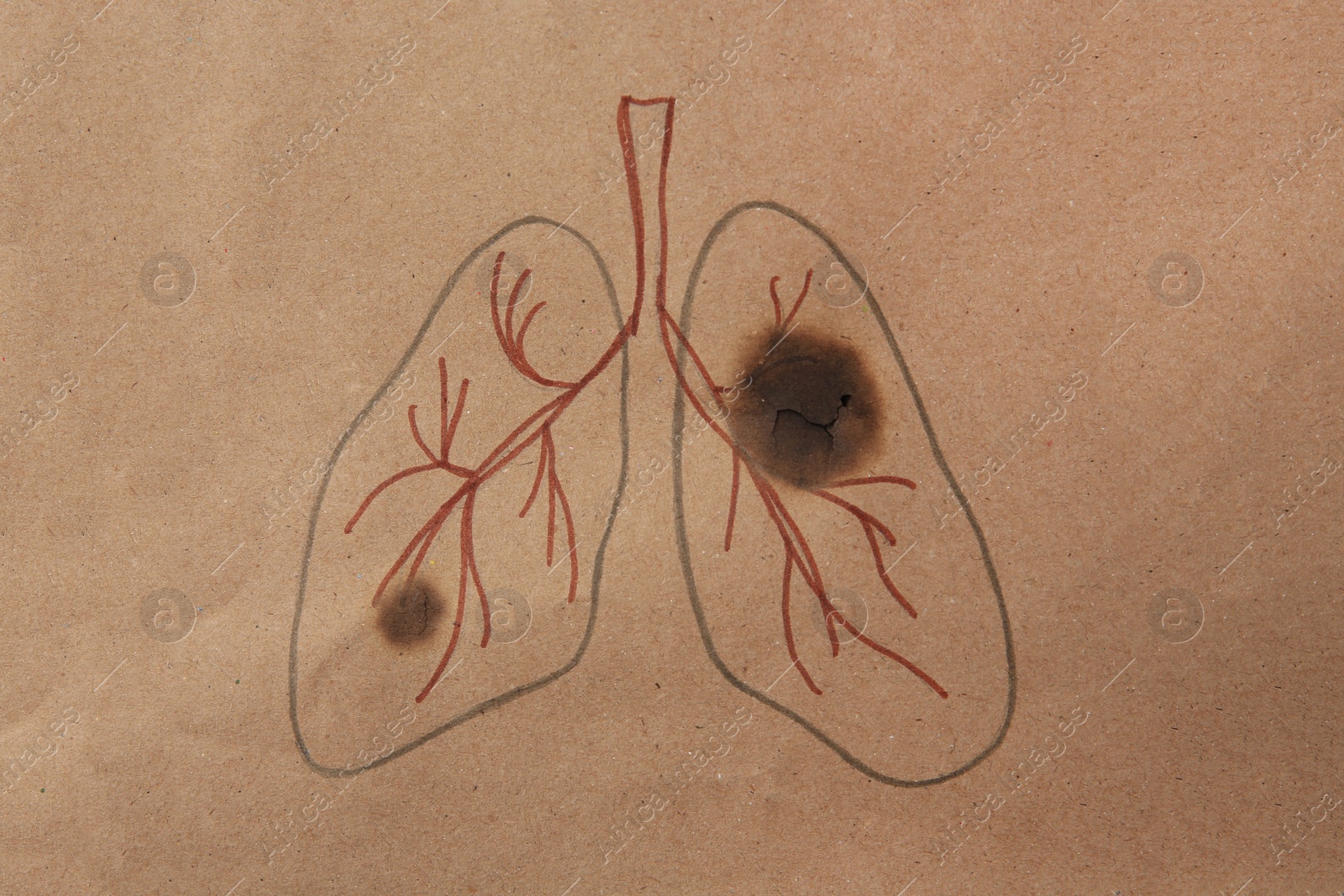 Photo of Drawn human lungs with cigarette holes on kraft paper, top view. No smoking concept