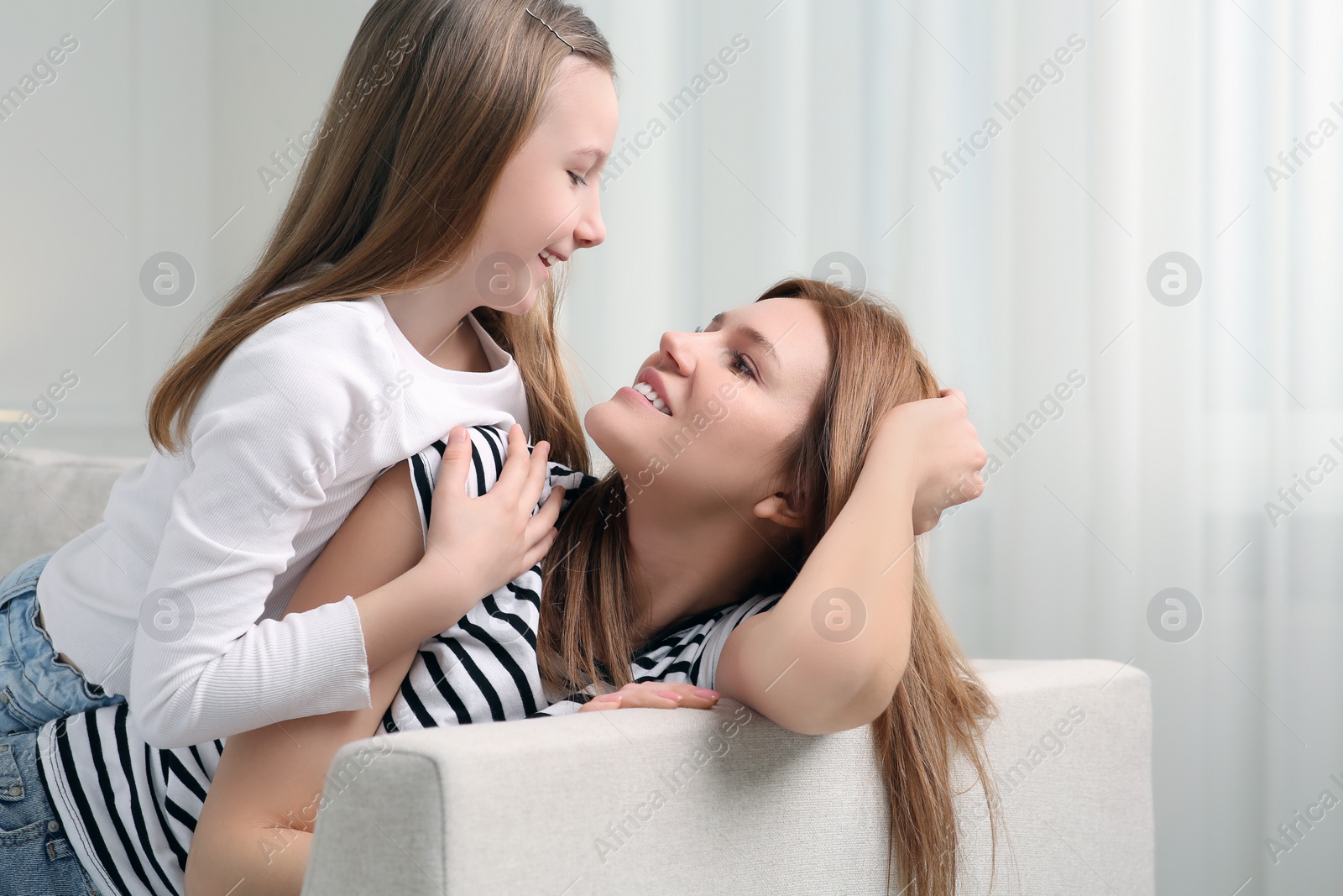 Photo of Mother and her cute daughter spending time together at home