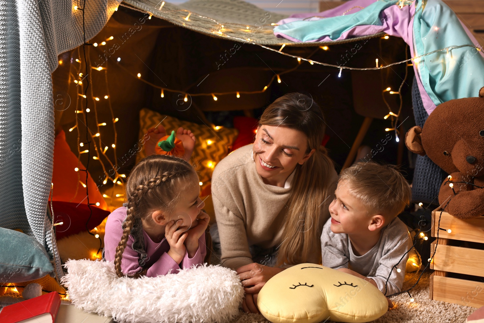 Photo of Mother and her children in play tent at home