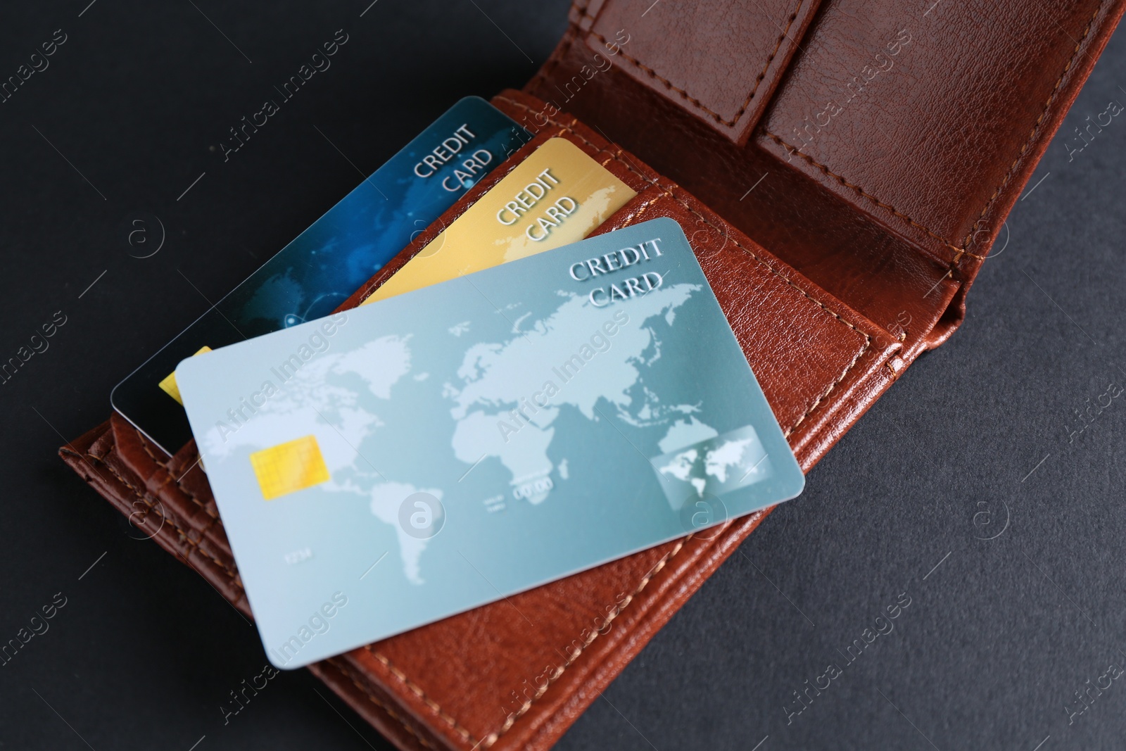 Photo of Leather wallet with credit cards on grey table