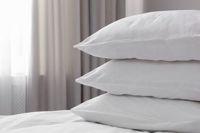 Photo of White soft pillows on bed. Space for text