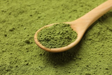 Photo of Spoon and green matcha powder, closeup view