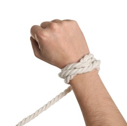 Photo of Freedom concept. Man with tied rope on his hand against white background, closeup