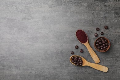 Photo of Flat lay composition with acai powder and fresh berries on gray table