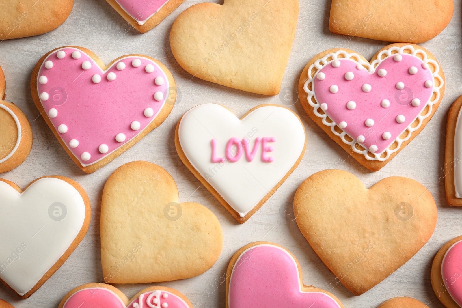 Photo of Decorated heart shaped cookies on color background, top view. Valentine's day treat