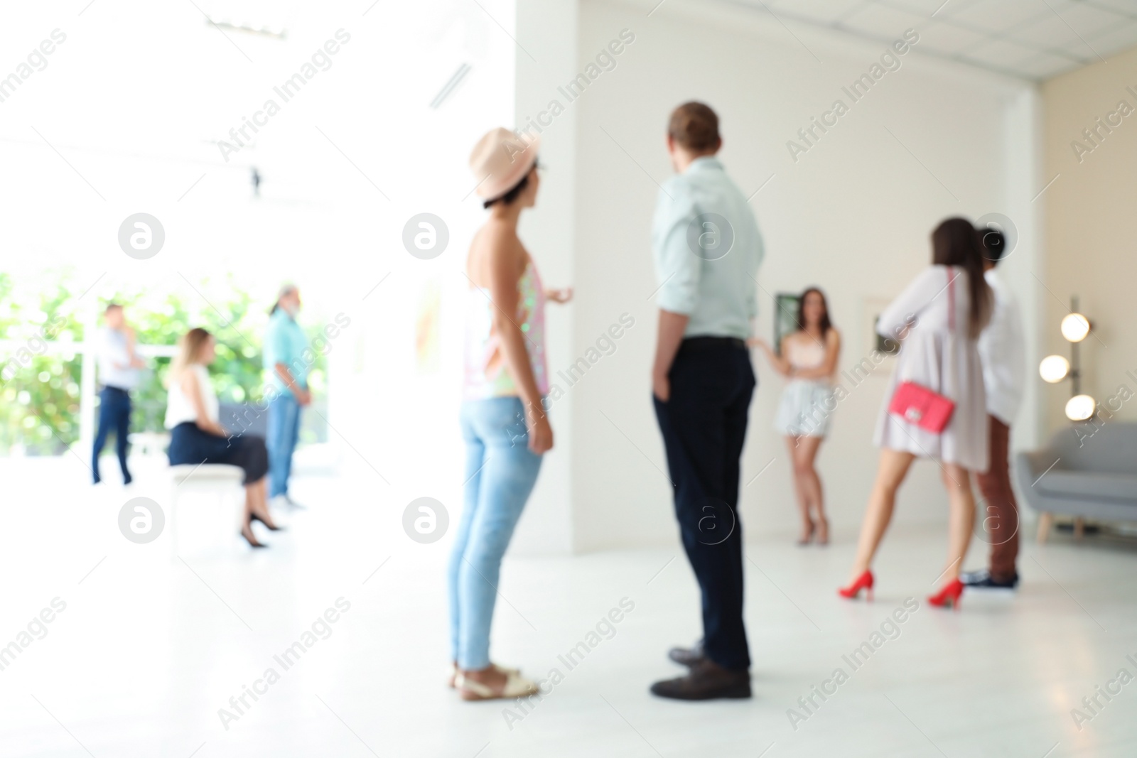 Photo of Blurred view of people at exhibition in art gallery