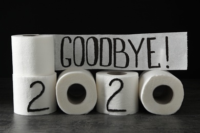 Photo of Text Goodbye 2020 made with toilet paper on grey stone background