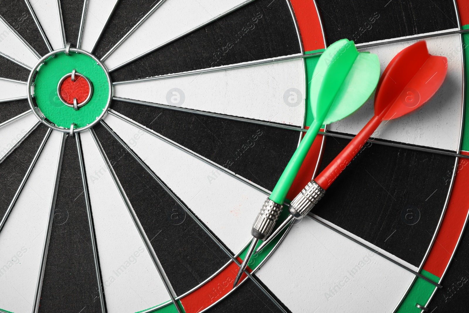 Photo of Red and green arrows on dart board, top view