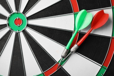 Red and green arrows on dart board, top view