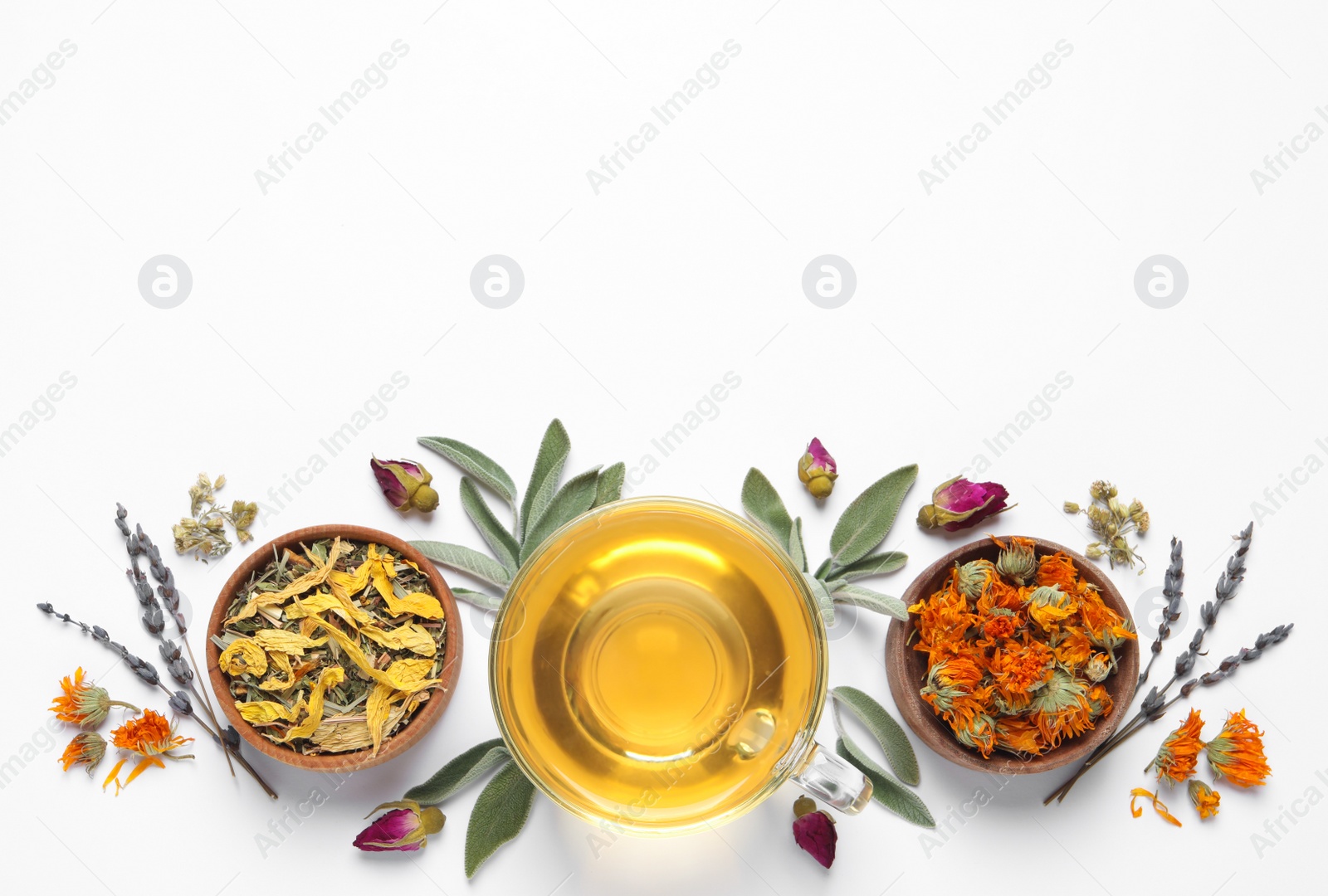 Photo of Freshly brewed tea and dried herbs on white background, top view. Space for text