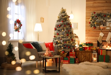 Image of Beautiful Christmas tree in living room, bokeh effect. Festive interior