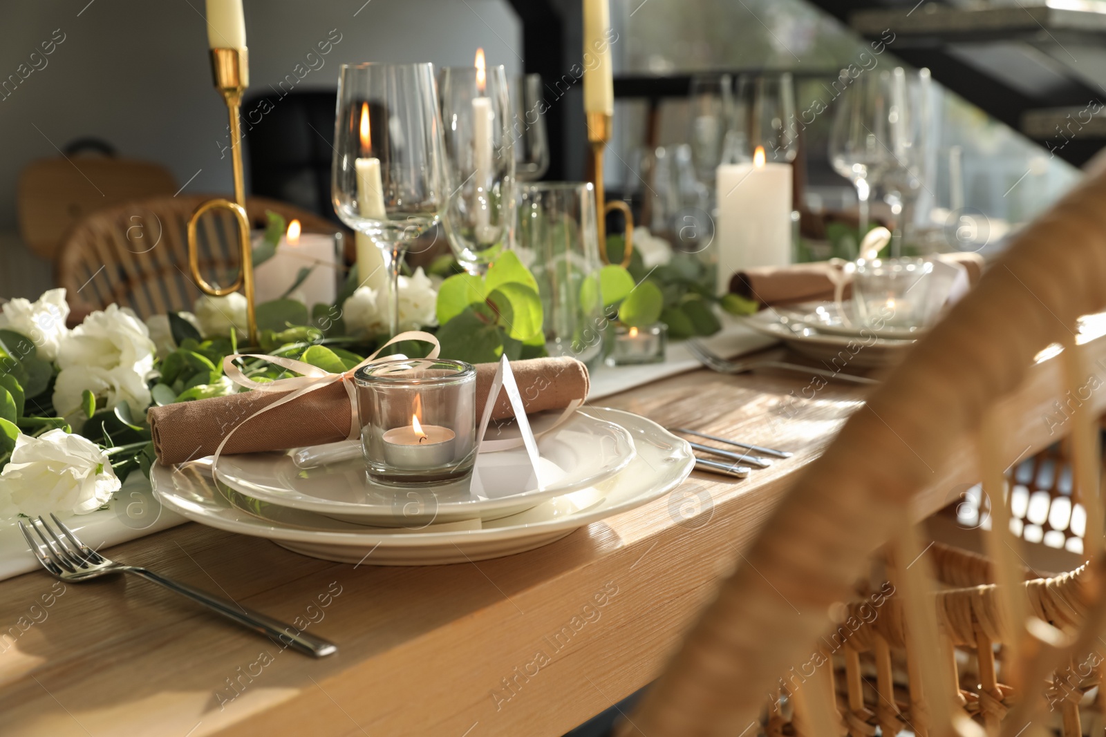 Photo of Elegant table setting with beautiful floral decor and burning candle