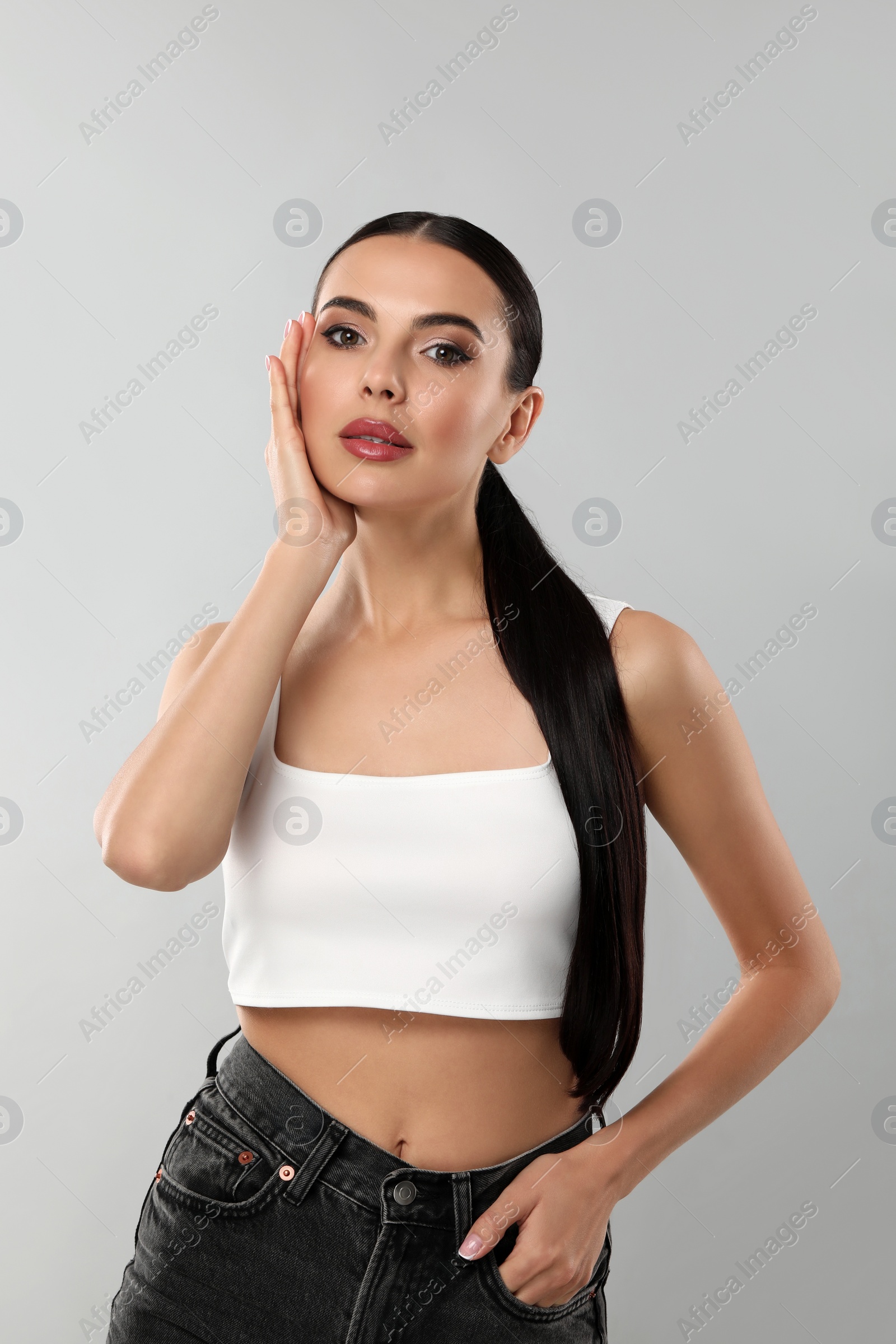 Photo of Beautiful woman wearing makeup on light grey background